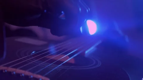 The devil monster plays the guitar. A mystical man in a mask in a dark studio Stock Footage 250530587
