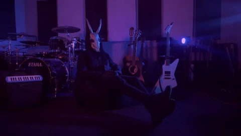 The devil monster is sitting in a dark room. A mystical man in a scary mask Stock Footage 250530515