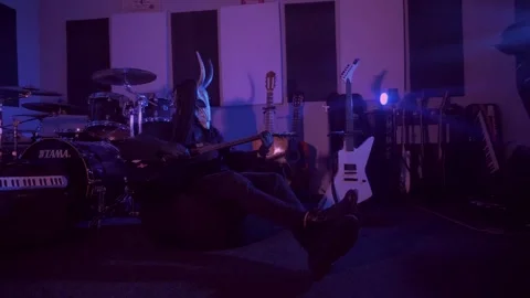 The devil monster is sitting in a dark room. A mystical man in a scary mask Stock Footage 250530566