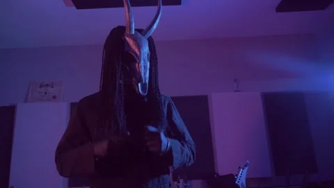 Devil monster wears a mask on his head in a dark room. A mystical man Stock Footage 250530378
