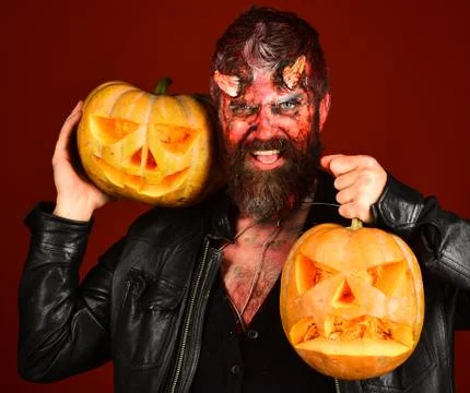Devil or monster with October decorations. Man wearing scary makeup Foto stock