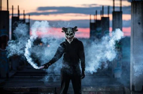 Devil with scary mask surrounded by white smoke Foto stock