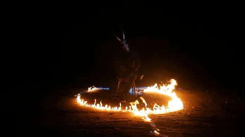 The devil sits on a chair and burns. Monster burning. A man burns on a chair. Ha Stock Footage 123403715