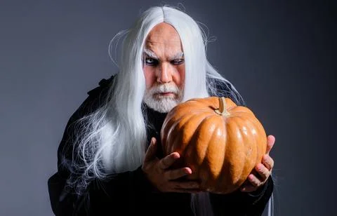 Devil vampire man with Halloween pumpkin. Horror. Male demon with Jack-o-lant Stock Photos