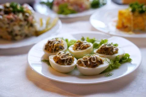 Deviled eggs aka stuffed eggs. Traditional Ukrainian food on the holiday table. Stock Photos