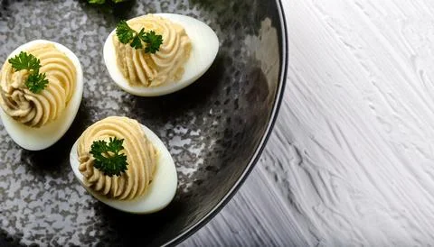 Deviled eggs, also known as stuffed, curried or dressed eggs, are hard boil.. Stock Photos