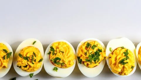 Deviled eggs, also known as stuffed, curried or dressed eggs, are hard boil.. Stock Photos