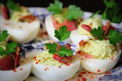 Deviled eggs appetizer with avocado and bacon Foto stock