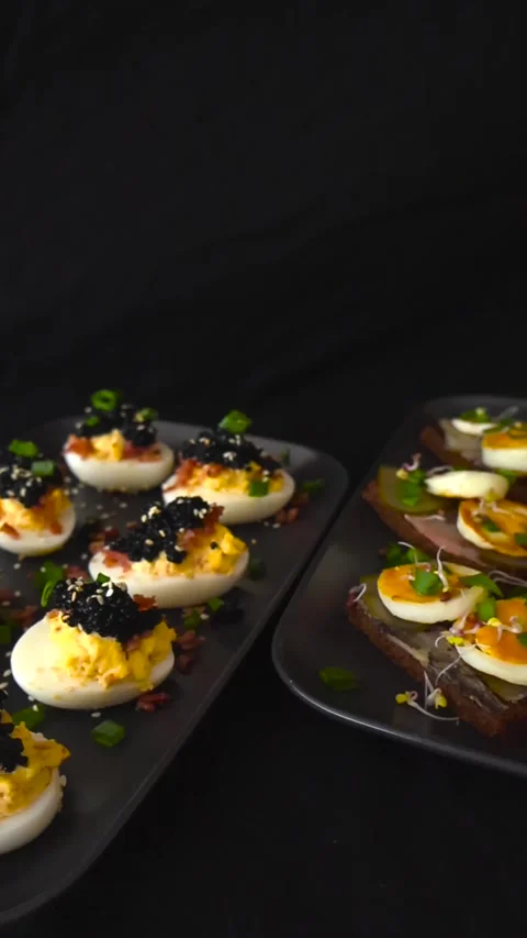 Deviled Eggs With Black Caviar and Sprat Sandwiches Appetizers Stock Footage 332620338
