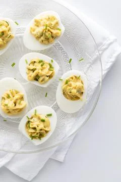 Deviled eggs on a decorative glass plate ready for sharing. 스톡 사진