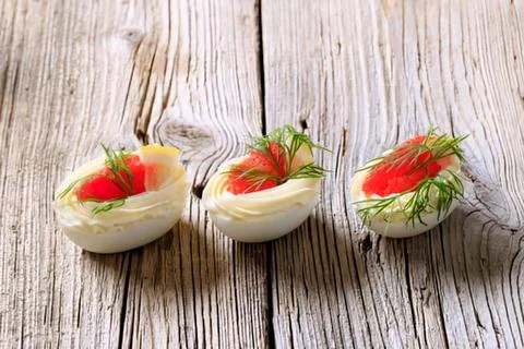 Deviled eggs with dill and tomato garnish Stock Photos