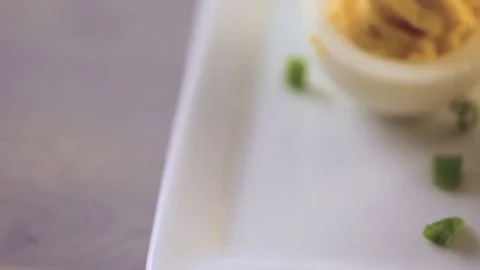 Deviled eggs garnished with green onions and bacon. Video stock 69725751
