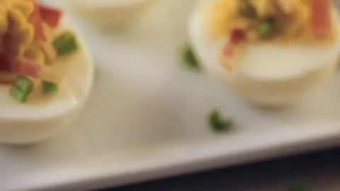 Deviled eggs garnished with green onions and bacon. Video stock 69725842