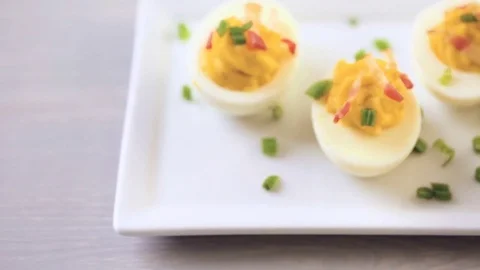 Deviled eggs garnished with green onions and bacon. Video stock 69725905