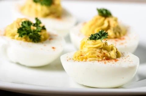 Deviled eggs garnished with parsley and paprika Stock Photos