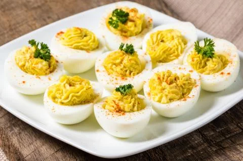 Deviled eggs garnished with parsley and paprika Stock Photos