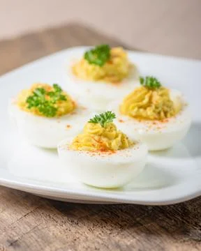 Deviled eggs garnished with parsley and paprika Stock Photos