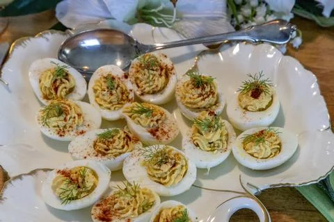 Deviled eggs with hummus in a porcelain dish rimmed with gold on an Easter .. Stock Photos