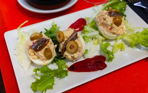 Deviled eggs with olives. Stuffed egg halves Stock Photos