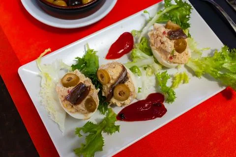 Deviled eggs with olives. Stuffed egg halves Stock Photos