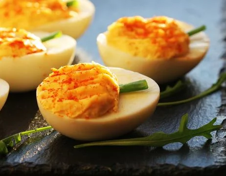 Deviled eggs with red pepper Stock Photos