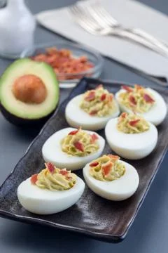 Deviled eggs stuffed with avocado, egg yolk and mayonnaise filling Stock Photos