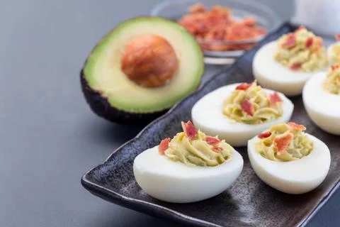 Deviled eggs stuffed with avocado, egg yolk and mayonnaise filling Stock Photos