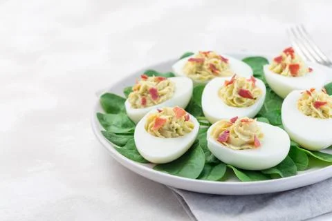 Deviled eggs stuffed with avocado, egg yolk and mayonnaise filling Photos