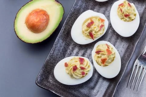 Deviled eggs stuffed with avocado, egg yolk and mayonnaise filling Stock Photos