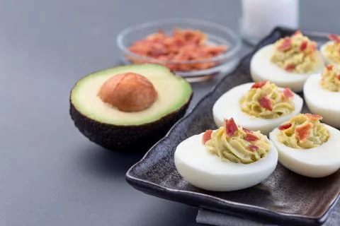 Deviled eggs stuffed with avocado, egg yolk and mayonnaise filling Stock Photos