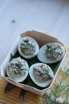 Deviled eggs with tuna and capers in a wooden serving tray Stock Photos