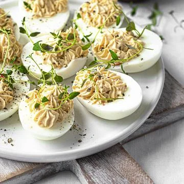 Deviled eggs on a white plate Stock Photos