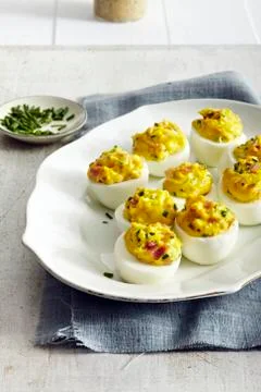 Devilish eggs on platter, studio shot Stock Photos