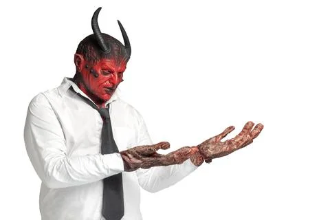 Devilman is standing with an open palm and showing something Stock Photos