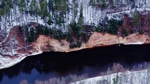 Devil's Cave and Red Cliffs of Velnala on Gauja River in Wintertime Sigulda Stock Footage 323048747