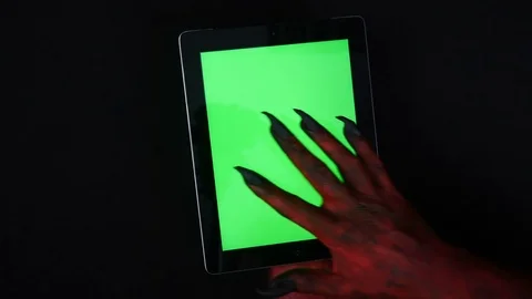 Devil's hand uses tablet PC with a green screen. Video stock 80424599
