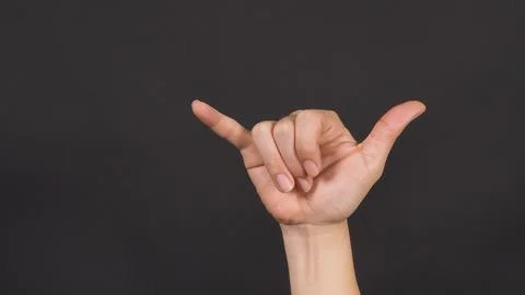 Devil's horns hand sign on background.forehand. Stock Photos