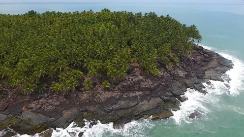 Devil's Island with coconut trees and rocks sideway drone view . Stock-Footage 95988197