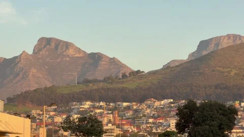 Devils Peak and Table Mountain at sunset as seen from Sea Point. Video stock 336488471