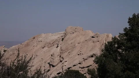 Devil's Punchbowl rock formation with sitting hikers static shot realtime Stock Footage 47566706