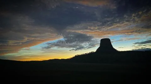 Devil’s Tower, Wyoming with the sun setting in the western sky Stock Photos