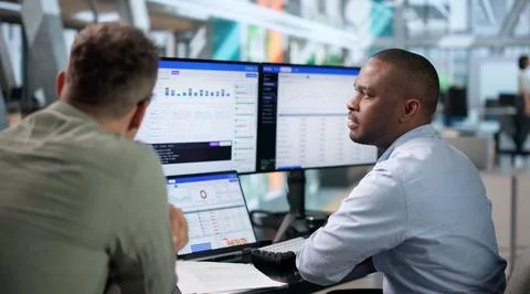 DevOps Engineer Monitors Continuous Delivery Pipeline Status Using Laptop. Stock Photos