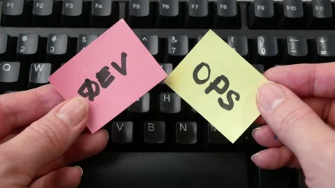 Devops stickers on keyboard concept, software scrum agile board with paper task, Stock Footage 258110540