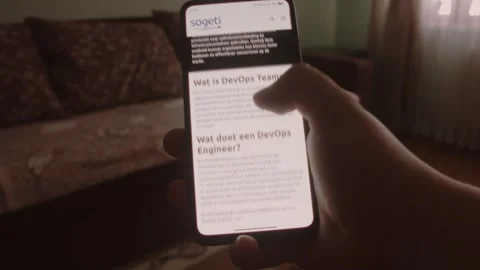DevOps Teams. Searching information about DevOps Teams on mobile phone screen. Stock Footage 249819676