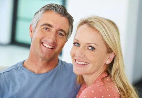 Devoted to each other. Portrait of a loving mature couple at home. Stock Photos