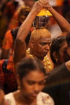 Devotee balances sacred vessel on head Stock Photos