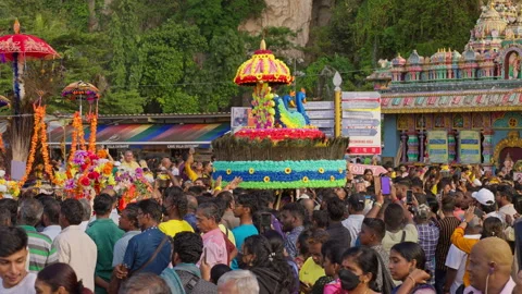 Devotee carrying large kavadi with peacock jumping up and down by the Batu Caves Video stock 271605313