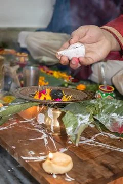 Devotee doing religious ritual of holy god with conch shell and blurred backg Stock Photos