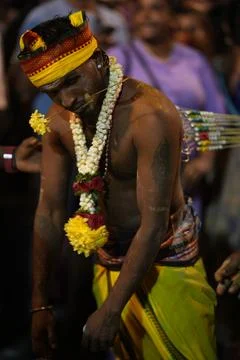 A devotee enters trance-like focus while bearing piercings and garlands Stock Photos