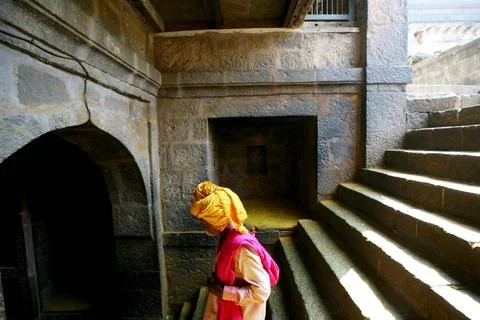 Devotee getting down from stairs at Jejuri temple, Pune, Phaltan, Maharash... Stock Photos